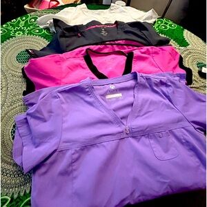 Four individual scrub tops